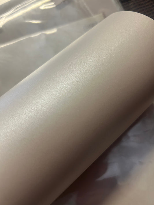 A stack of shimmer white 100gsm vellum A4 paper with a pearly shimmer, intended for use in invitations and card projects.