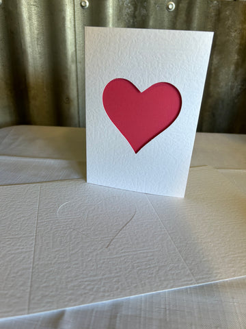 3 panel card with heart aperture, die cut heart, textured finish