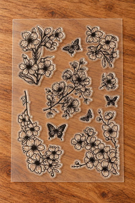 A sheet of clear acrylic or rubber stamp designs featuring floral branches, cherry blossoms and butterflies